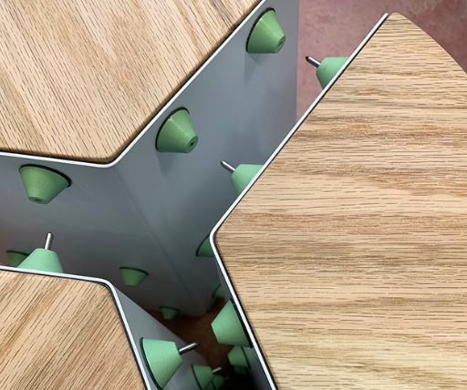 Spacers bridging the folded panels under the seat