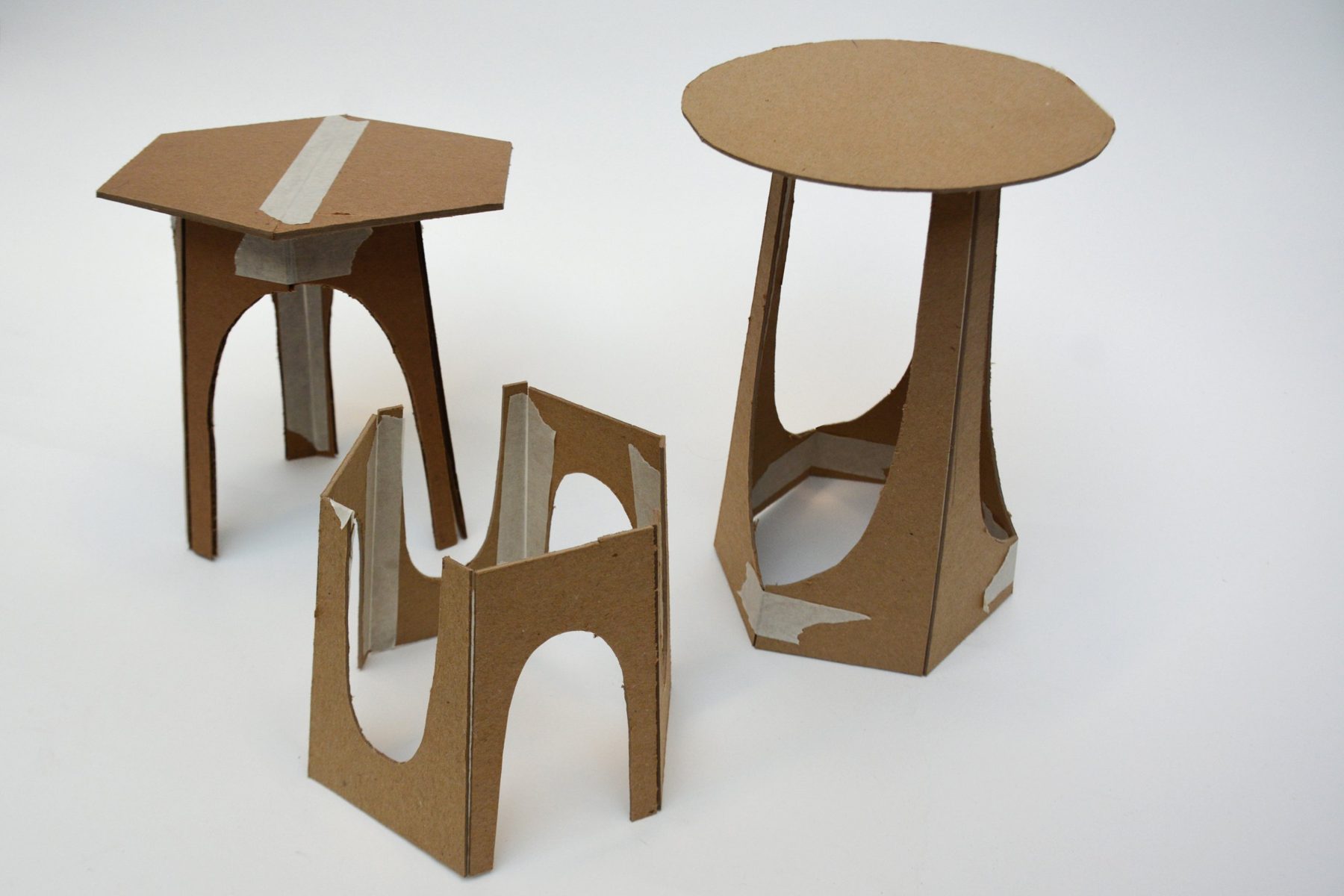 Cardboard stool studies with arched cutouts