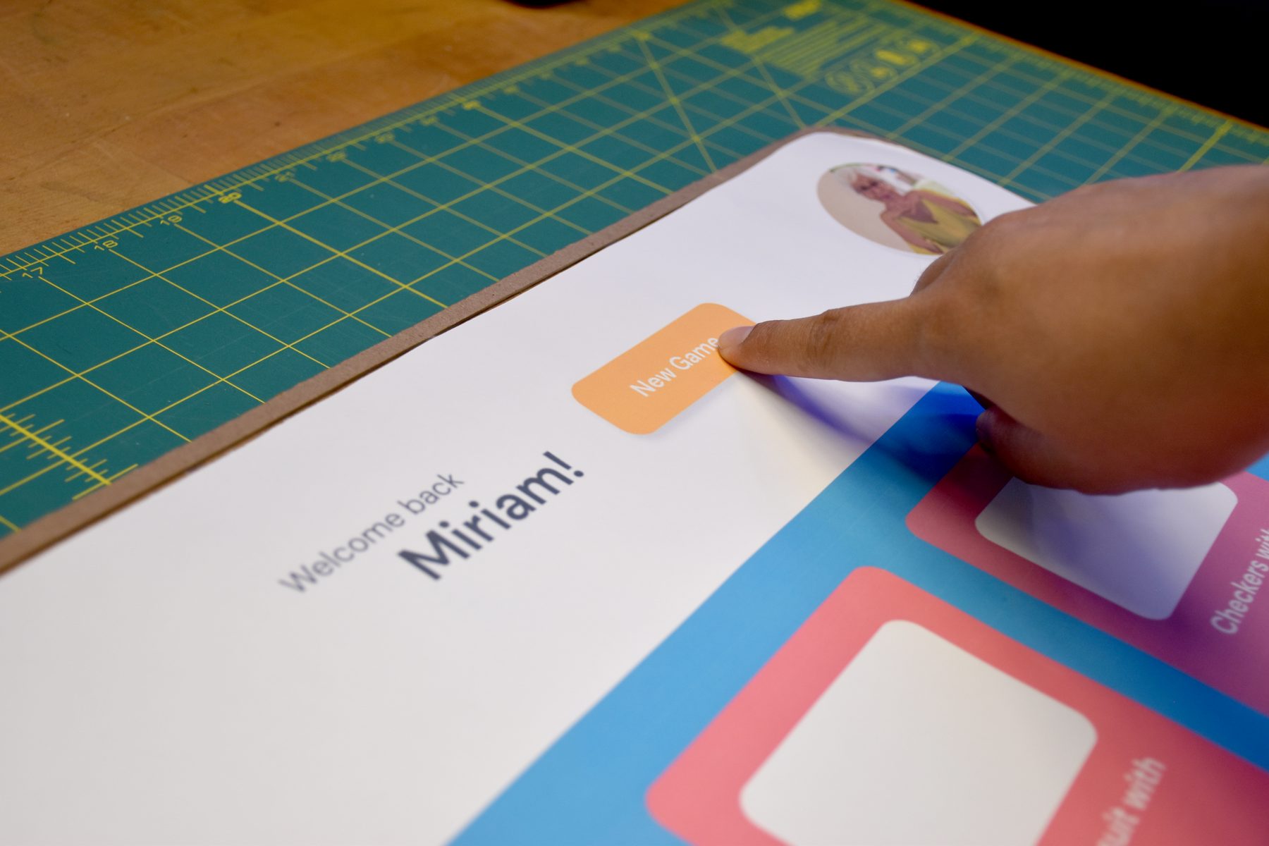 Tapping the New Game button on a paper prototype of the home screen