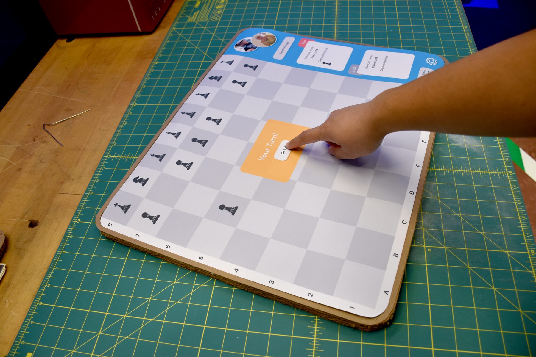Tapping the Your Turn prompt on a paper prototype of the chess screen